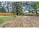 Large backyard featuring a wooden fence and mature trees at 1790 Brockington Ave, Charleston, SC 29407