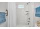 The remodeled bathroom boasts a clean white tile surround, white shower curtain, and glass block window at 1790 Brockington Ave, Charleston, SC 29407