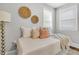 Cozy bedroom with a twin-sized daybed, soft cushions, a unique gold lamp, and natural light from a window at 1790 Brockington Ave, Charleston, SC 29407