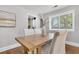 Sunlit dining area with wooden table and white chairs at 1790 Brockington Ave, Charleston, SC 29407