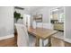 Bright dining room with wooden table and seating, neutral colors, and a view of the kitchen area at 1790 Brockington Ave, Charleston, SC 29407