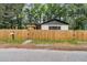 Charming home exterior with a wooden fence, mailbox, and lush trees, offering privacy and curb appeal at 1790 Brockington Ave, Charleston, SC 29407