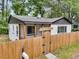 Charming cottage with fenced yard and inviting entry gate at 1790 Brockington Ave, Charleston, SC 29407