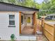 A charming covered front porch with wood trim, a yellow front door, and a ramp for easy access at 1790 Brockington Ave, Charleston, SC 29407