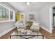 Inviting living room with hardwood floors, yellow door, and comfortable seating at 1790 Brockington Ave, Charleston, SC 29407