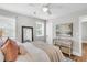 View of the main bedroom featuring a ceiling fan, hardwood floors, a mirror, and a decorative console table at 1790 Brockington Ave, Charleston, SC 29407