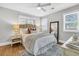 A bright main bedroom features hardwood floors, neutral tones, a ceiling fan, and natural light from two windows at 1790 Brockington Ave, Charleston, SC 29407