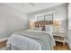 The main bedroom features hardwood floors, neutral tones, a ceiling fan, and natural light from a large window at 1790 Brockington Ave, Charleston, SC 29407