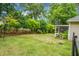Spacious backyard offering a serene view of mature trees, a fence, and a cozy screened porch at 184 Angora Way, Summerville, SC 29485