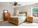 Bright bedroom featuring a wooden bed frame, matching dressers, and a window with a view of the outdoors at 184 Angora Way, Summerville, SC 29485