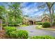 Welcoming community entrance with a circular driveway, lush landscaping, and a charming brick entryway at 184 Angora Way, Summerville, SC 29485
