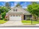 Charming brick home with a manicured lawn, an attached two-car garage, and a cozy front porch at 184 Angora Way, Summerville, SC 29485