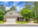 Lovely brick home with well-kept lawn, inviting front porch with rocking chairs and a two-car garage at 184 Angora Way, Summerville, SC 29485
