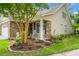 Inviting home with a brick facade, rocking chairs on the front porch, and a beautifully landscaped garden at 184 Angora Way, Summerville, SC 29485