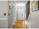 Bright foyer featuring wood floors, a staircase, and a white front door with transom windows at 184 Angora Way, Summerville, SC 29485
