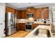 Well-lit kitchen featuring stainless steel appliances, granite countertops, and wooden cabinets at 184 Angora Way, Summerville, SC 29485