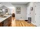 Open floor plan with wood floors, stainless trash can and view of dining room with chandelier at 184 Angora Way, Summerville, SC 29485