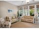 Bright sunroom with bamboo furniture, ceiling fan, and large windows looking out to the landscaped yard at 184 Angora Way, Summerville, SC 29485