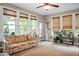 Bright living room with a floral sofa, multiple windows, and ceiling fan for a light and airy atmosphere at 184 Angora Way, Summerville, SC 29485