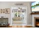 View of living room with a fireplace and a sofa through an arched entry in a neutral decor at 184 Angora Way, Summerville, SC 29485