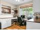 Bright and airy office space featuring custom built-in shelving, a large window, and hardwood floors at 184 Angora Way, Summerville, SC 29485