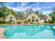 Serene community pool reflects the surrounding homes, with ample seating for residents' relaxation at 184 Angora Way, Summerville, SC 29485
