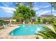 Community swimming pool with lounge chairs, lush landscaping, and serene view of surrounding homes at 184 Angora Way, Summerville, SC 29485
