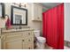 Cozy bathroom with a granite-look countertop, traditional vanity, and a striking red shower curtain at 188 Midland Parkway # 110, Summerville, SC 29485