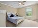 Bedroom with neutral carpet, light walls, a ceiling fan, a neatly made bed, and a sunny window at 188 Midland Parkway # 110, Summerville, SC 29485