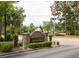 Community entrance sign featuring brick pillars, landscaping, and American flag at 188 Midland Parkway # 110, Summerville, SC 29485