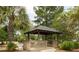 Community gazebo on wooden deck, featuring seating, landscaping, and a pond with fountain at 188 Midland Parkway # 110, Summerville, SC 29485