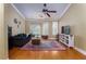 The well-lit living room boasts hardwood floors, a ceiling fan, and a bay window for added charm at 188 Midland Parkway # 110, Summerville, SC 29485