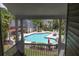 Community swimming pool surrounded by lounge chairs, tables, and greenery, seen from a balcony at 188 Midland Parkway # 110, Summerville, SC 29485