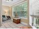 Bright sitting area featuring large windows with nature views, modern chair, and neutral toned walls and floors at 188 Midland Parkway # 110, Summerville, SC 29485