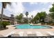 A refreshing swimming pool surrounded by chairs, lush landscaping, and beautiful multi-story apartments at 188 Midland Parkway # 110, Summerville, SC 29485