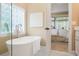 Serene bathroom boasting a stylish standalone tub and a view into the primary bedroom at 1985 Shields Ln, Mount Pleasant, SC 29466