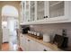 Elegant butler's pantry with white cabinets, granite countertops, and convenient serving area at 1985 Shields Ln, Mount Pleasant, SC 29466