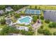 Aerial view of community pool with tennis courts, playground, and ample seating surrounded by lush greenery at 1985 Shields Ln, Mount Pleasant, SC 29466