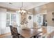 Charming dining area with a modern chandelier and sunlit windows dressed with decorative curtains at 1985 Shields Ln, Mount Pleasant, SC 29466