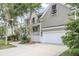 Side view of a well-maintained home with an attached garage and a beautifully landscaped yard at 1985 Shields Ln, Mount Pleasant, SC 29466