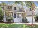 Inviting two-story home featuring a charming front porch, well-manicured lawn, and attached garage at 1985 Shields Ln, Mount Pleasant, SC 29466