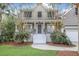Charming home with a welcoming front porch, white railings, and lush landscaping in a desirable neighborhood at 1985 Shields Ln, Mount Pleasant, SC 29466