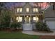 Charming two-story home with a welcoming front porch, lush landscaping, and warm, inviting lighting at 1985 Shields Ln, Mount Pleasant, SC 29466