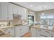 Well-lit kitchen with white cabinetry, granite countertops, and modern appliances at 1985 Shields Ln, Mount Pleasant, SC 29466