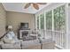 Comfortable screened patio with wicker furniture and cozy fireplace for relaxing outdoors at 1985 Shields Ln, Mount Pleasant, SC 29466