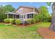 Beautiful backyard featuring a screened-in porch, lush landscaping, and well-maintained lawn at 2017 Woodland Shores Rd, Charleston, SC 29412