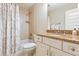 Well-lit bathroom with granite countertop, white cabinets, and a shower-tub combination at 2017 Woodland Shores Rd, Charleston, SC 29412