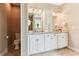 Bright bathroom features white cabinetry, granite counters, and double sinks at 2017 Woodland Shores Rd, Charleston, SC 29412