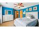 Charming bedroom with a bright blue color, features white furniture and ample natural light at 2017 Woodland Shores Rd, Charleston, SC 29412