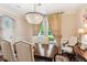 Elegant dining room with ornate chandelier and drapery at 2017 Woodland Shores Rd, Charleston, SC 29412